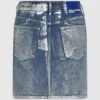 Mini-jupe en denim enduit Mini-jupe en denim enduit